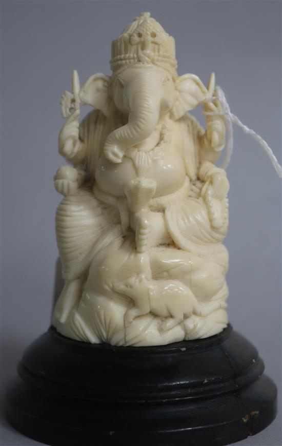 An Indian carved ivory figure of Ganesh, on ebonised socle